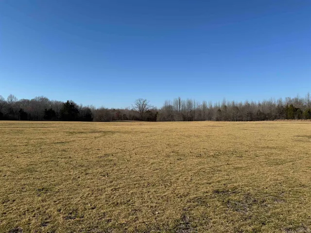 a view of lake with sunset in background