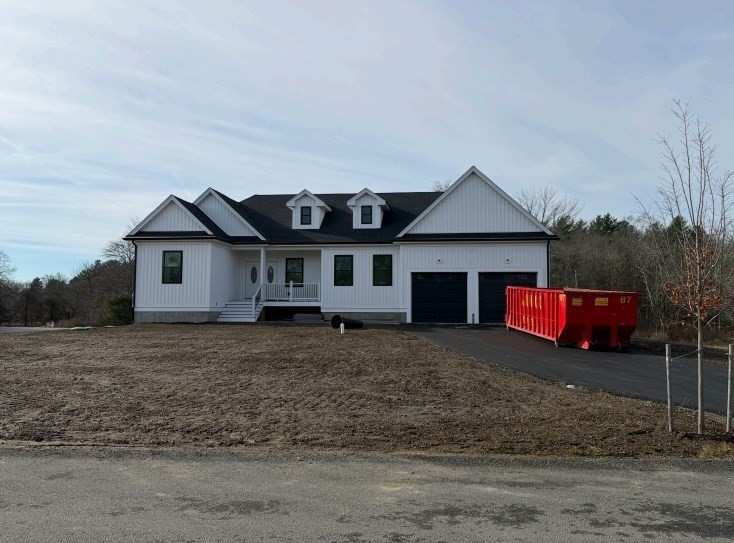 a view of a house with a yard next to a road