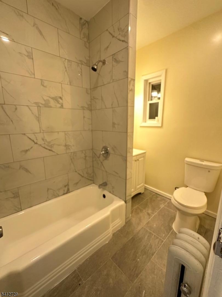 22 Cummings Street, Unit 3 Irvington, NJ 07111 - Photo 1 of 7 a bathroom with a shower and a toilet