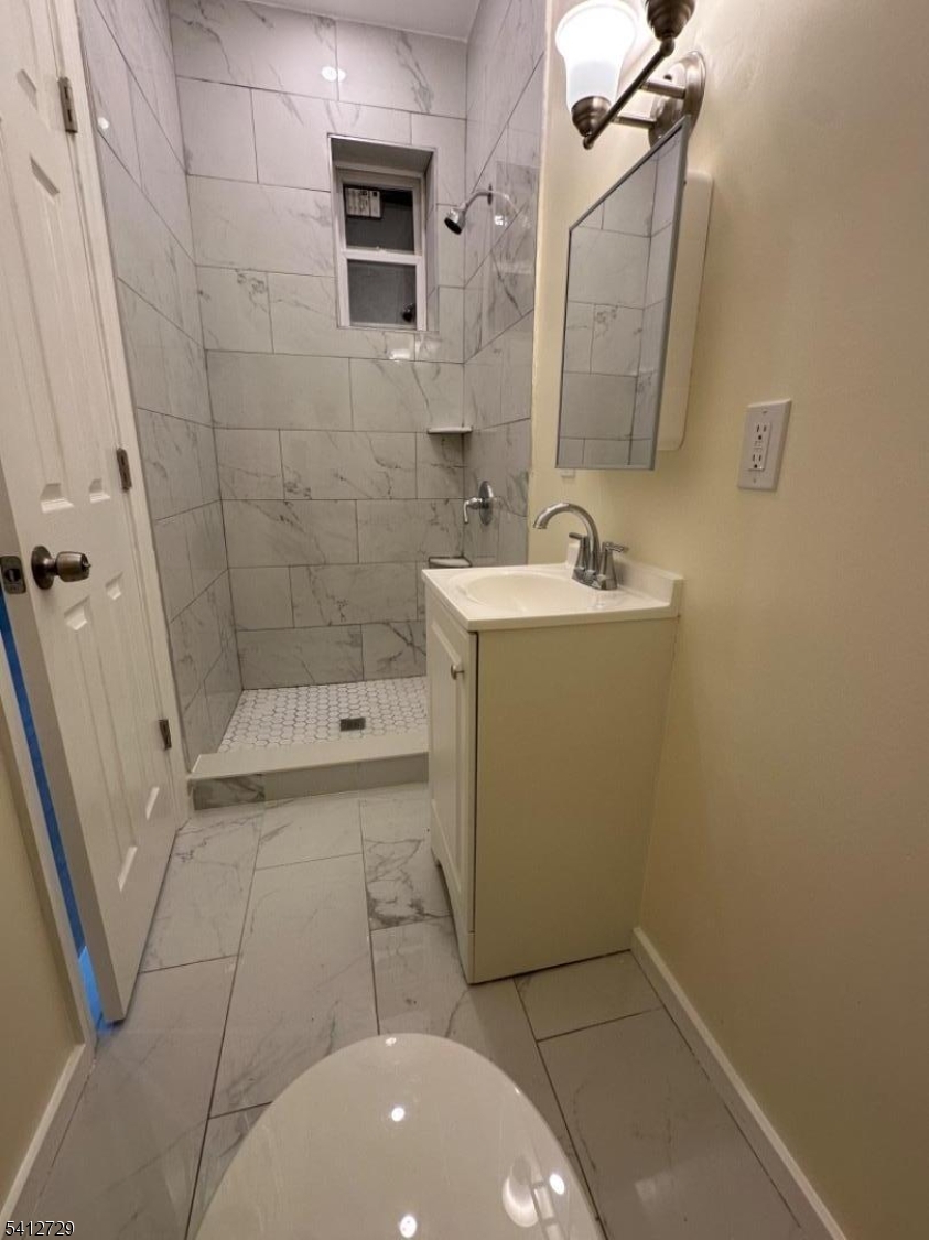 22 Cummings Street, Unit 3 Irvington, NJ 07111 - Photo 4 of 7 a bathroom with a sink a toilet and shower