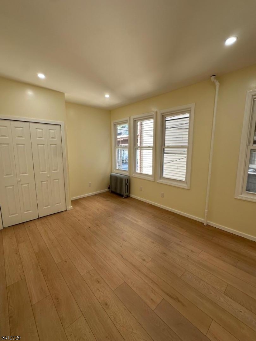 22 Cummings Street, Unit 3 Irvington, NJ 07111 - Photo 5 of 7 an empty room with windows