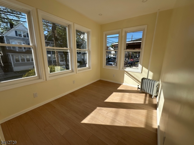 22 Cummings Street, Unit 3 Irvington, NJ 07111 - Photo 7 of 7 a view of an entryway with wooden floor and a yard