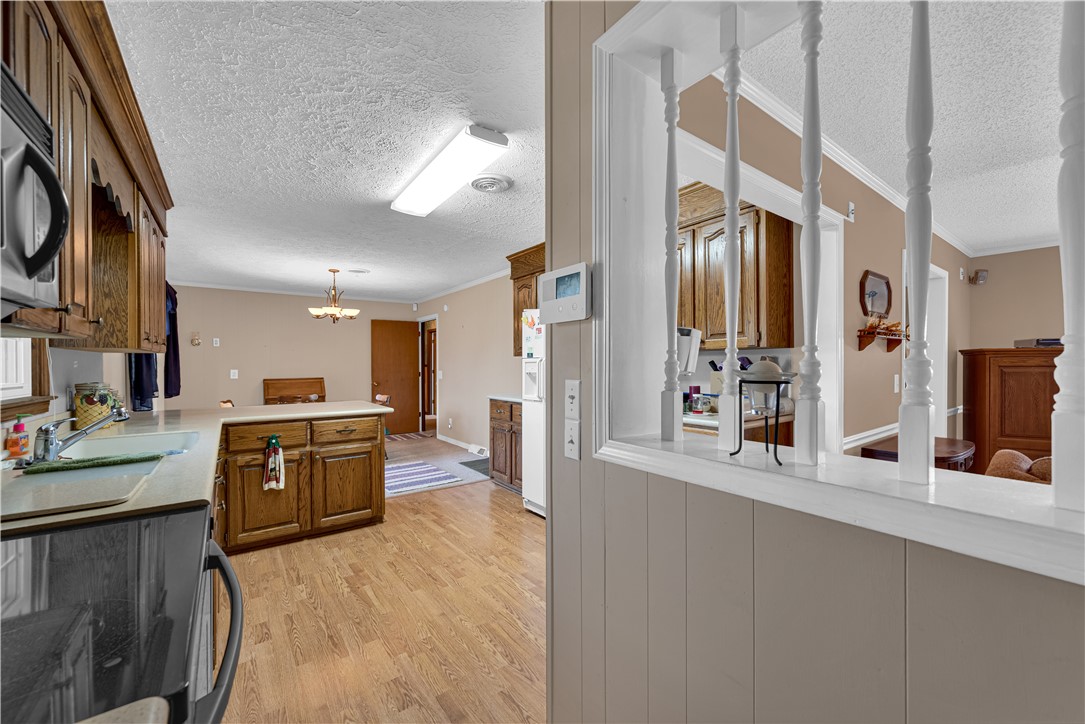 307 Calhoun Road Belton, SC 29627 - Photo 26 of 30 A well-equipped kitchen offers ample cabinet storage and a central island with a breakfast bar.