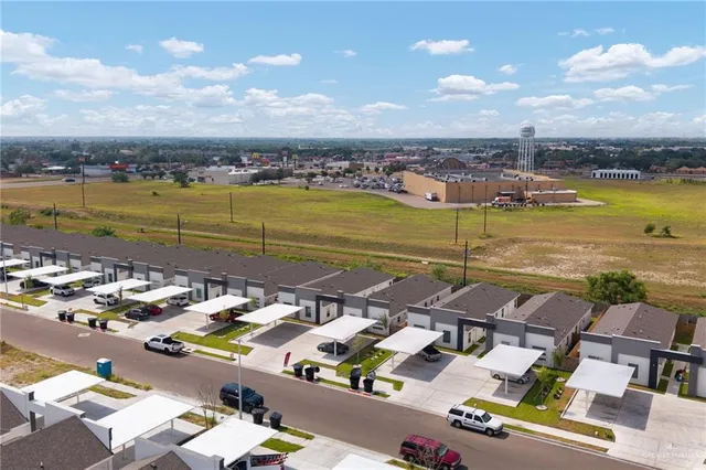 an aerial view of residential houses with outdoor space