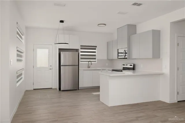 a kitchen with a refrigerator and a sink