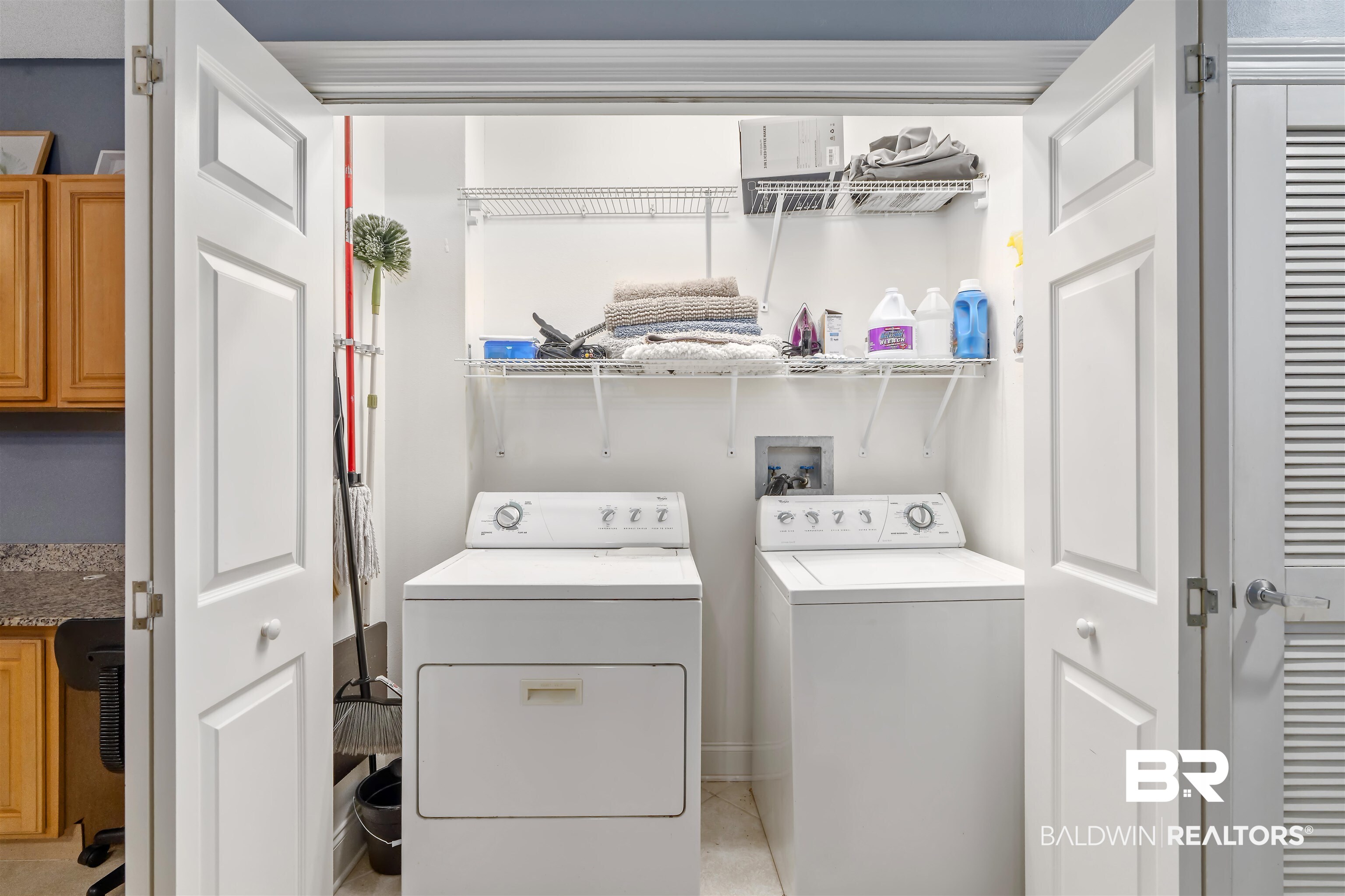 27800 Canal Road, Unit 113 Orange Beach, AL 36561 - Photo 19 of 35 Laundry area featuring washing machine and dryer and light tile patterned flooring