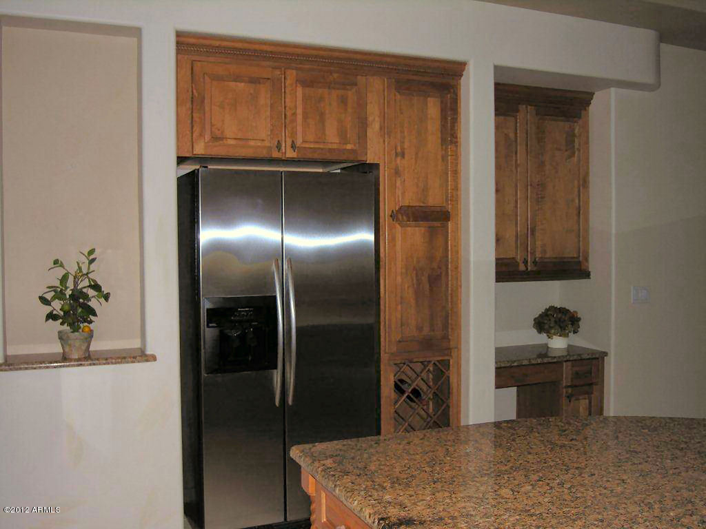 11517 East Ranch Gate Road Scottsdale, AZ 85255 - Photo 11 of 35 a kitchen with a refrigerator and a sink