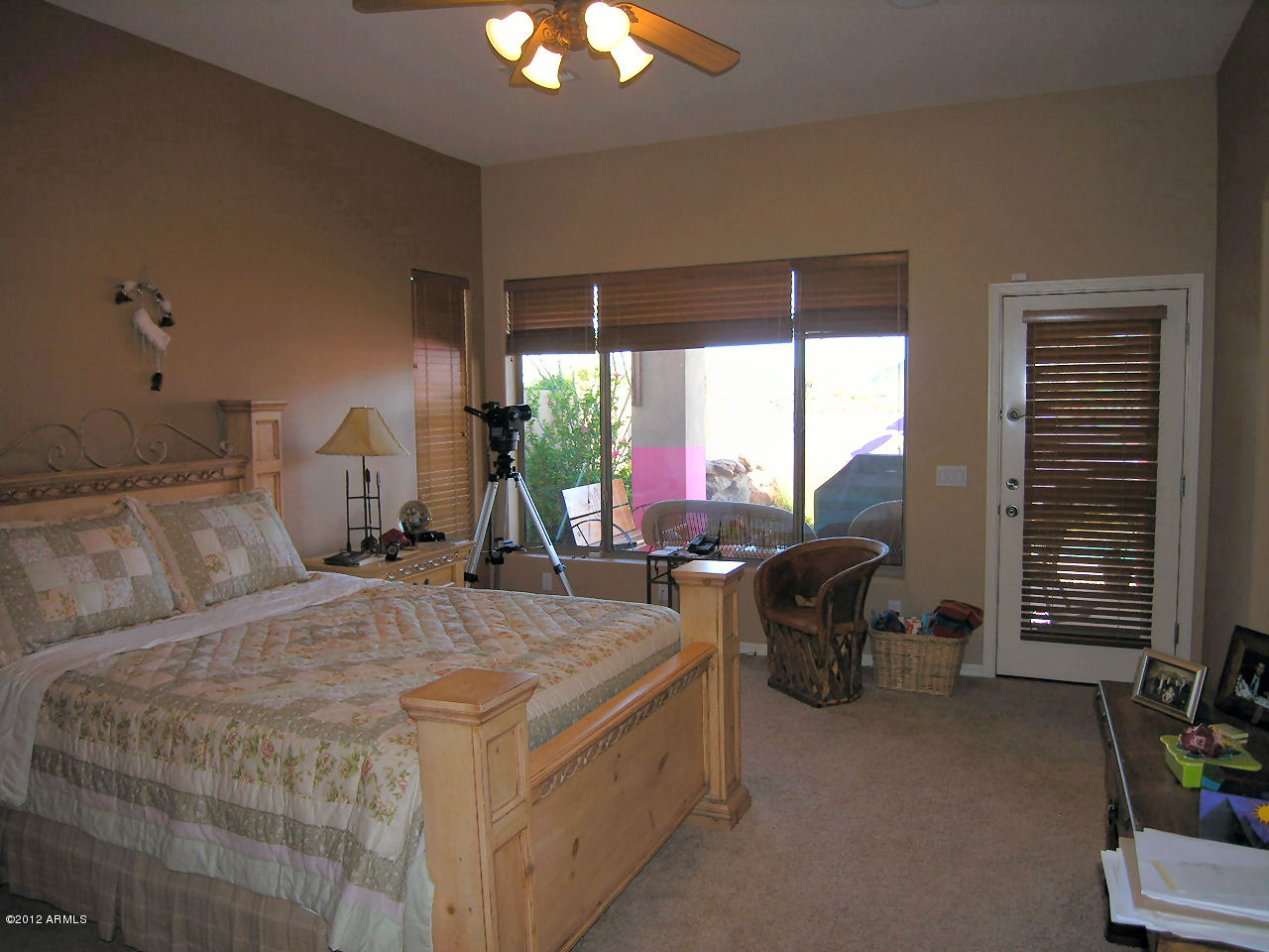 11517 East Ranch Gate Road Scottsdale, AZ 85255 - Photo 16 of 35 a bedroom with a bed and a chandelier