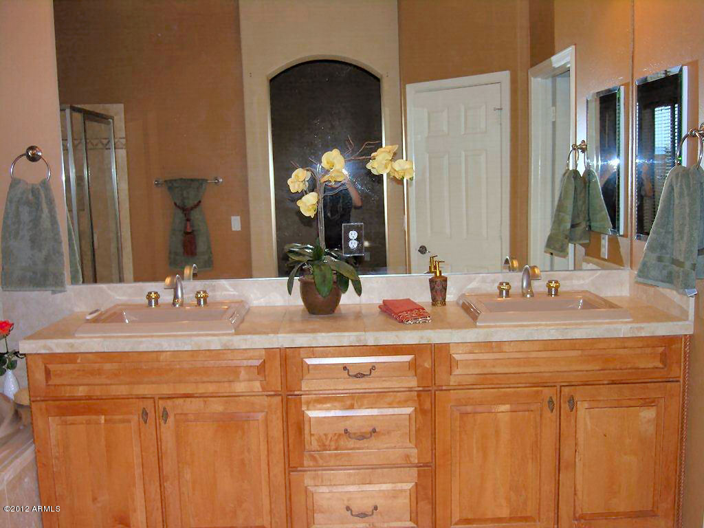 11517 East Ranch Gate Road Scottsdale, AZ 85255 - Photo 17 of 35 a bathroom with a sink and a mirror