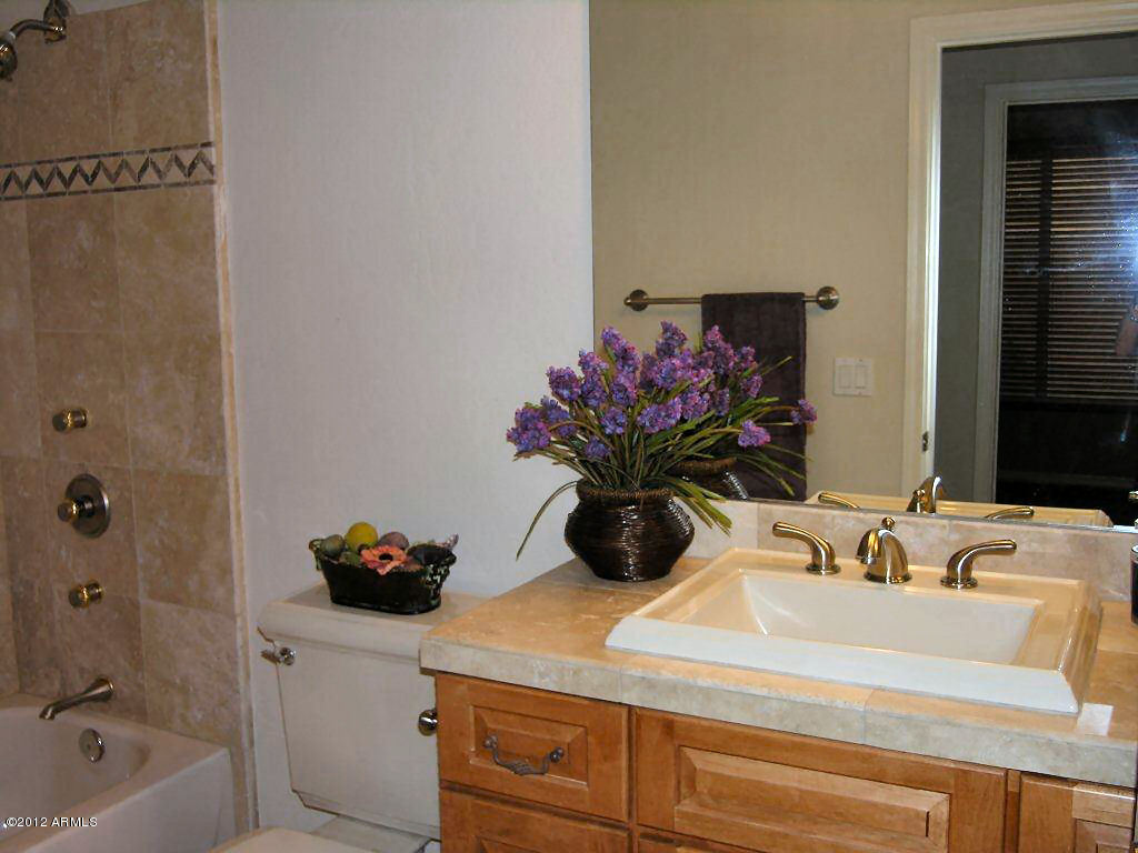 11517 East Ranch Gate Road Scottsdale, AZ 85255 - Photo 23 of 35 a bathroom with a sink and a mirror