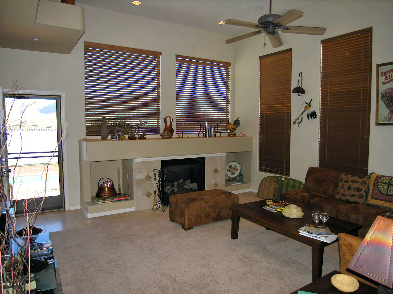 11517 East Ranch Gate Road Scottsdale, AZ 85255 - Photo 30 of 35 a living room with furniture and a fireplace
