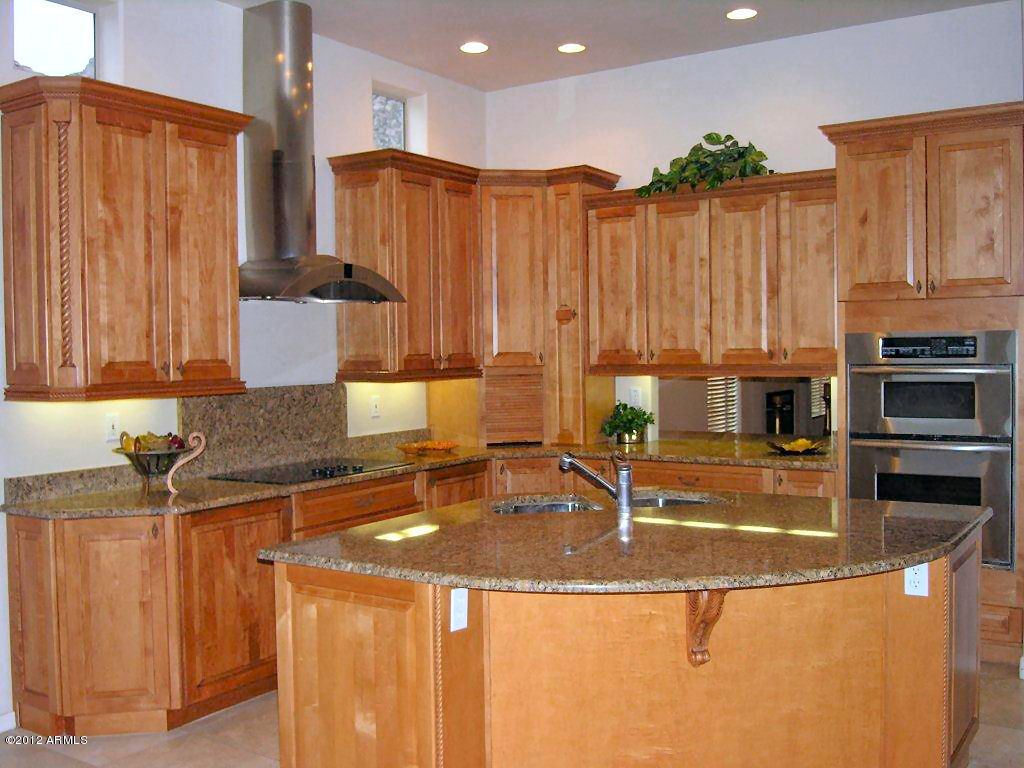 11517 East Ranch Gate Road Scottsdale, AZ 85255 - Photo 10 of 35 a kitchen with kitchen island granite countertop a sink and a stove