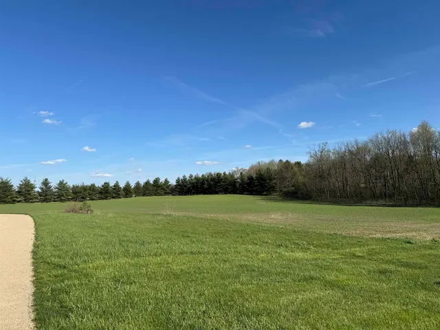 a view of a lake with houses in the background
