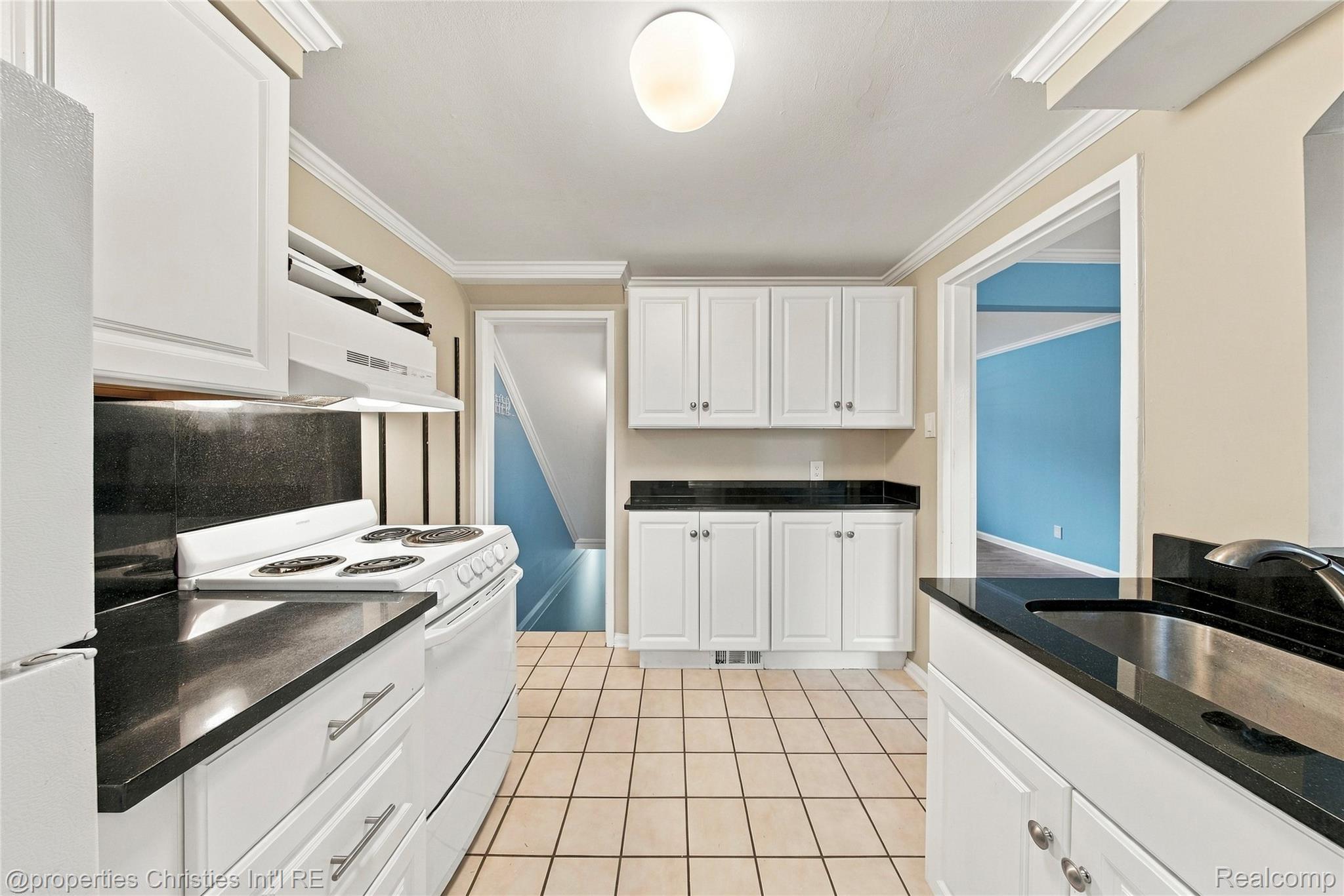 1642 Graefield Road, Unit 75 Birmingham, MI 48009 - Photo 10 of 25 Kitchen featuring white cabinetry, dark countertops, a tile floor, and a white range