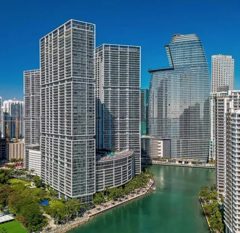 a front view of a building with a garden and plants