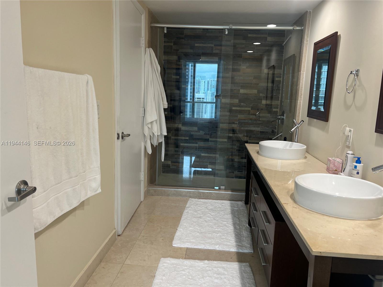 475 Brickell Avenue, Unit 3514 Miami, FL 33131 - Photo 9 of 16 a bathroom with a sink and a mirror