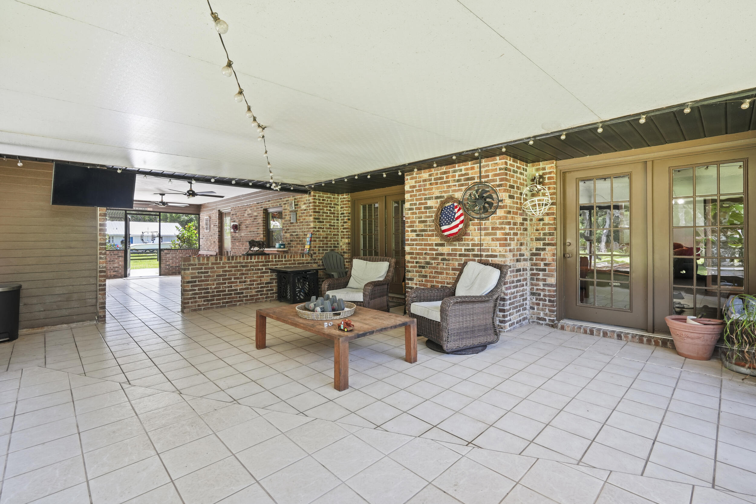 4170 McCarty Road Fort Pierce, FL 34945 - Photo 41 of 57 a living room with furniture and a flat screen tv