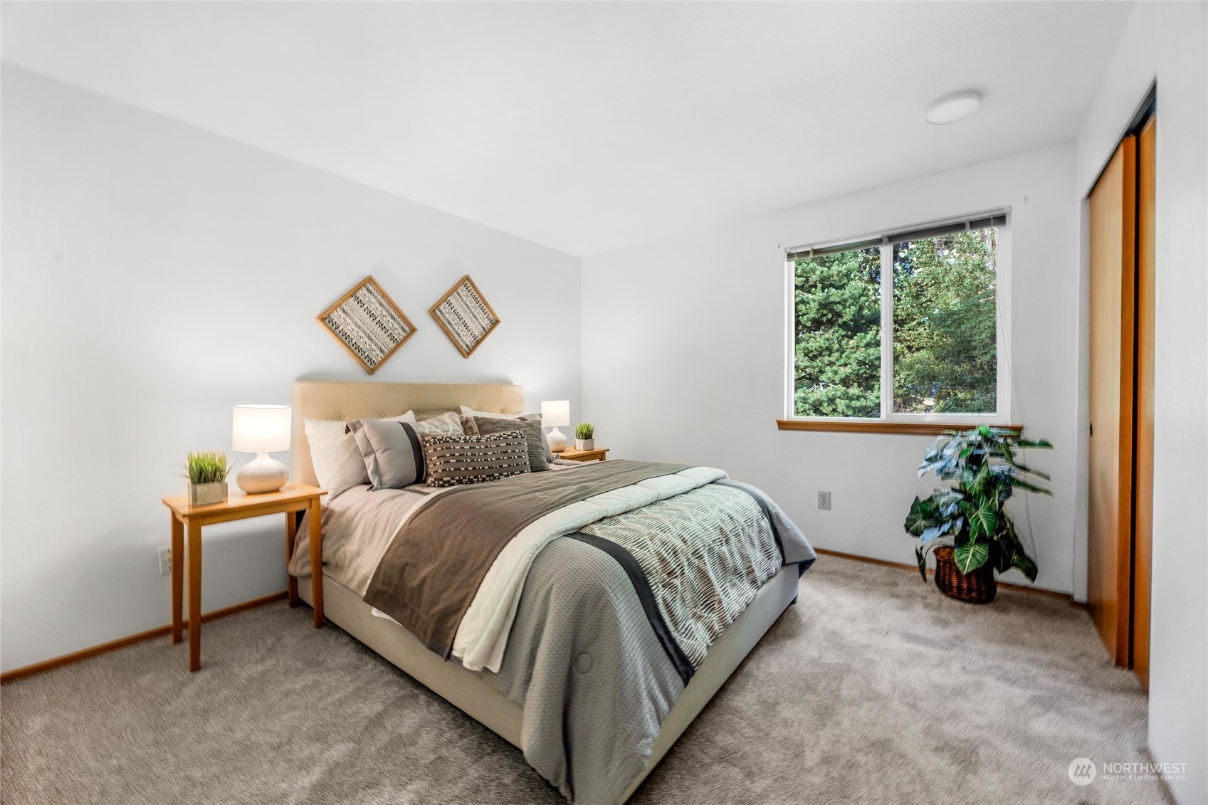 23323 12th Place West Bothell, WA 98021 - Photo 20 of 36 a bed room with a bed and a potted plant