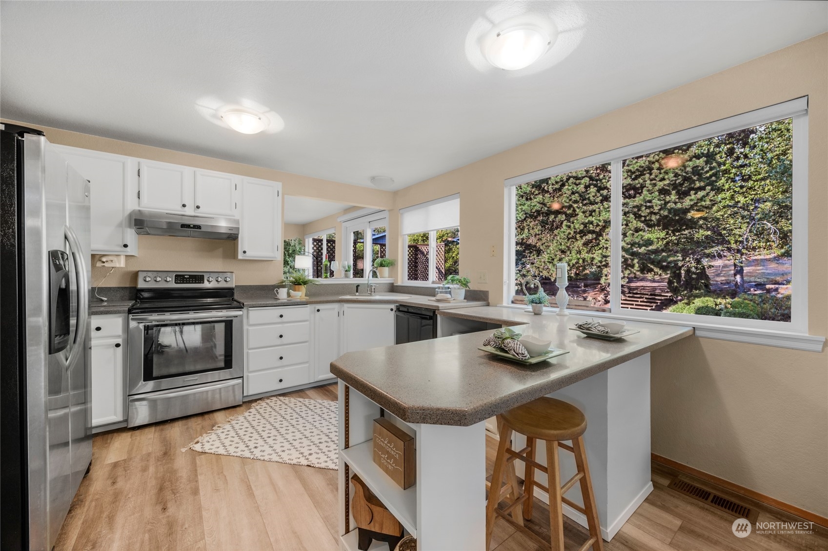 23323 12th Place West Bothell, WA 98021 - Photo 8 of 36 a kitchen with stainless steel appliances granite countertop a stove a sink and a refrigerator