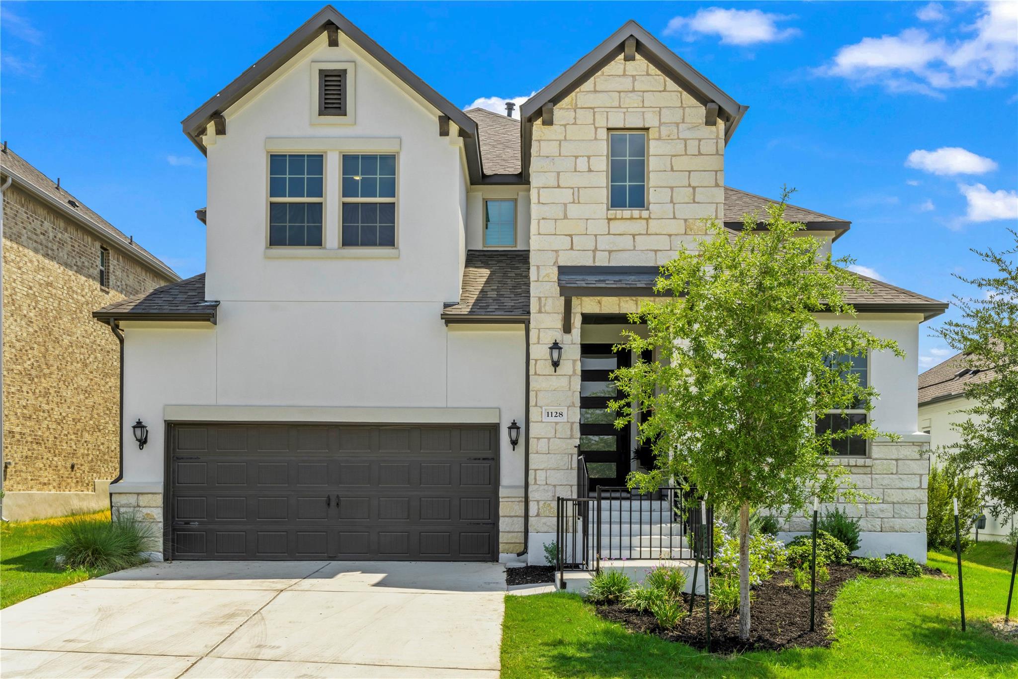 Crafted with elegant stone and stucco, this residence showcases a harmonious blend of textures and architectural design.