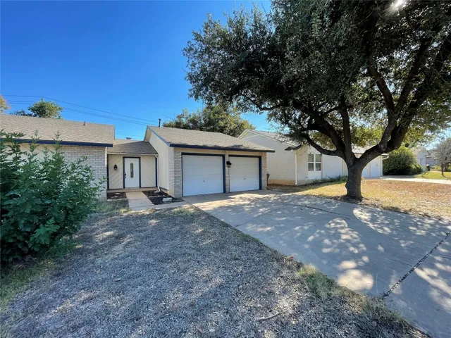 a front view of a house with a yard and a garage