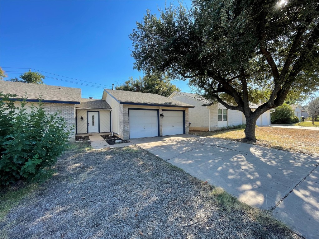 12013 Swallow Drive Austin, TX 78750 - Photo 1 of 25 a front view of a house with a yard and a garage