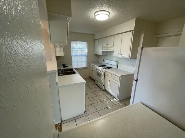 a kitchen with a stove and a refrigerator