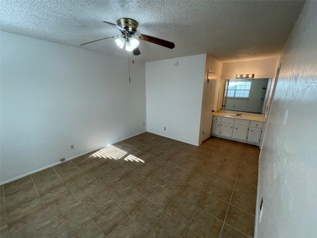 12013 Swallow Drive Austin, TX 78750 - Photo 15 of 25 an empty room with chandelier fan