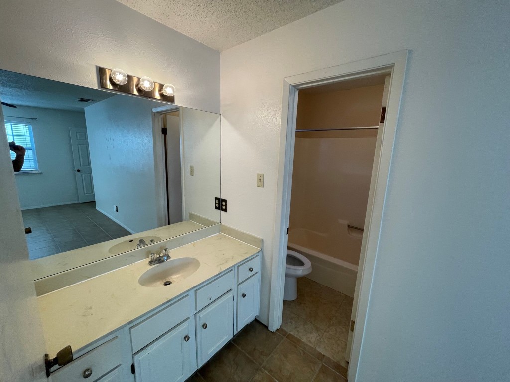 12013 Swallow Drive Austin, TX 78750 - Photo 16 of 25 a bathroom with a sink a toilet and shower