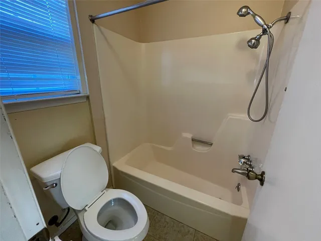 a bathroom with a toilet and a bathtub