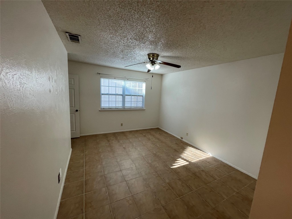 12013 Swallow Drive Austin, TX 78750 - Photo 5 of 25 an empty room with chandelier fan and windows