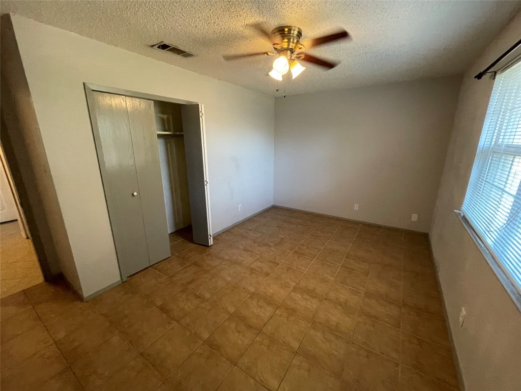 12013 Swallow Drive Austin, TX 78750 - Photo 6 of 25 an empty room with windows and fan