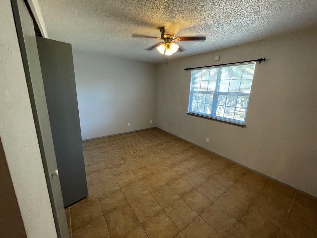12013 Swallow Drive Austin, TX 78750 - Photo 9 of 25 an empty room with windows and fan