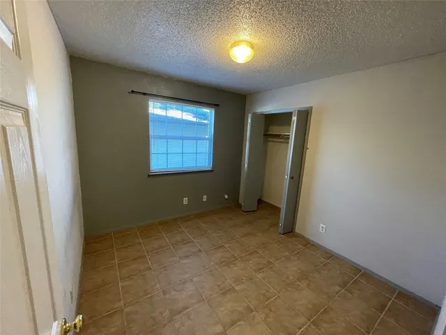 an empty room with a empty space and windows