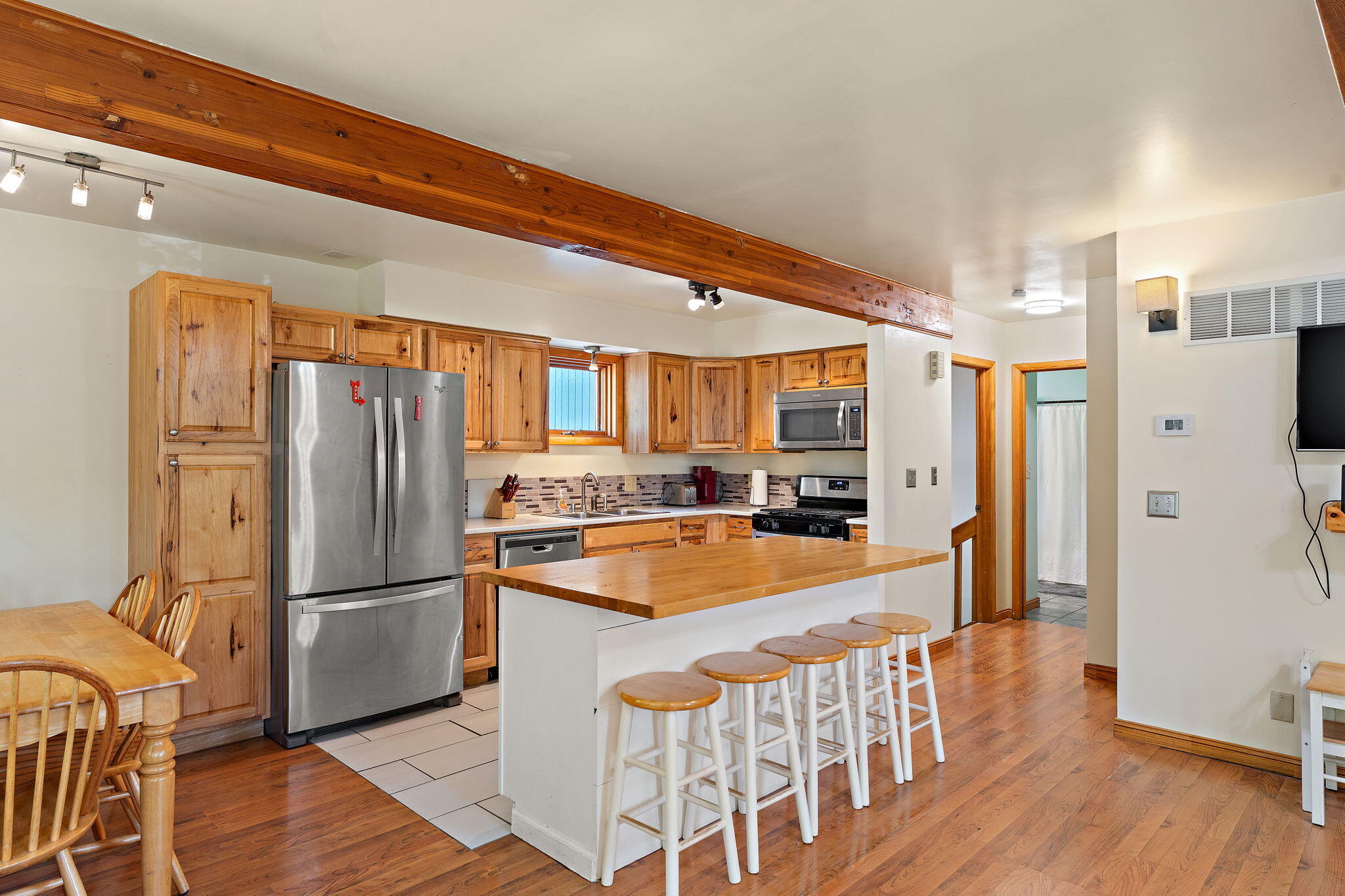 225 Warren Road Michigan City, IN 46360 - Photo 11 of 47 a kitchen with stainless steel appliances granite countertop a refrigerator a stove and a wooden floors