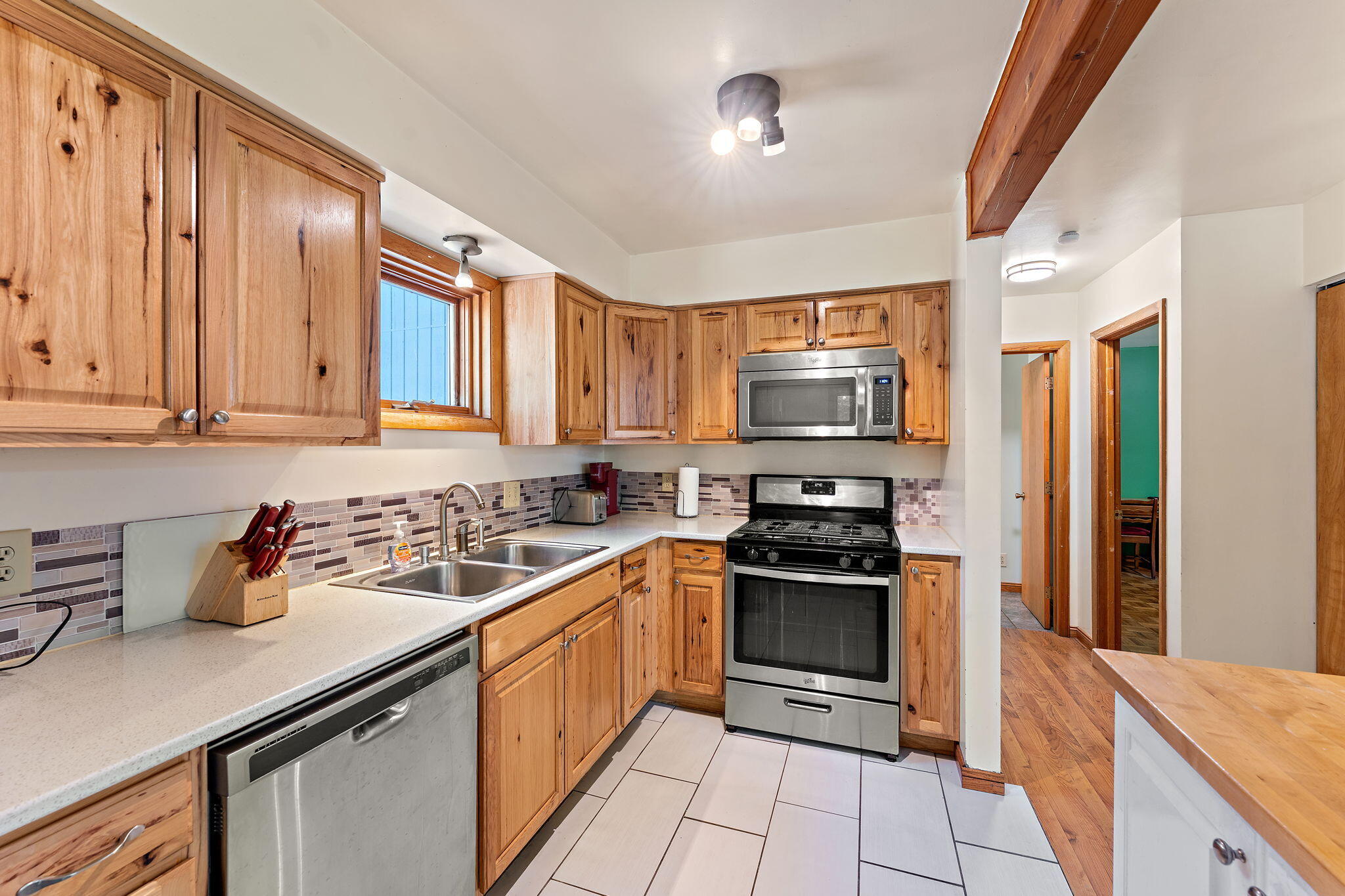 225 Warren Road Michigan City, IN 46360 - Photo 12 of 47 a kitchen with stainless steel appliances granite countertop a stove a sink and a refrigerator