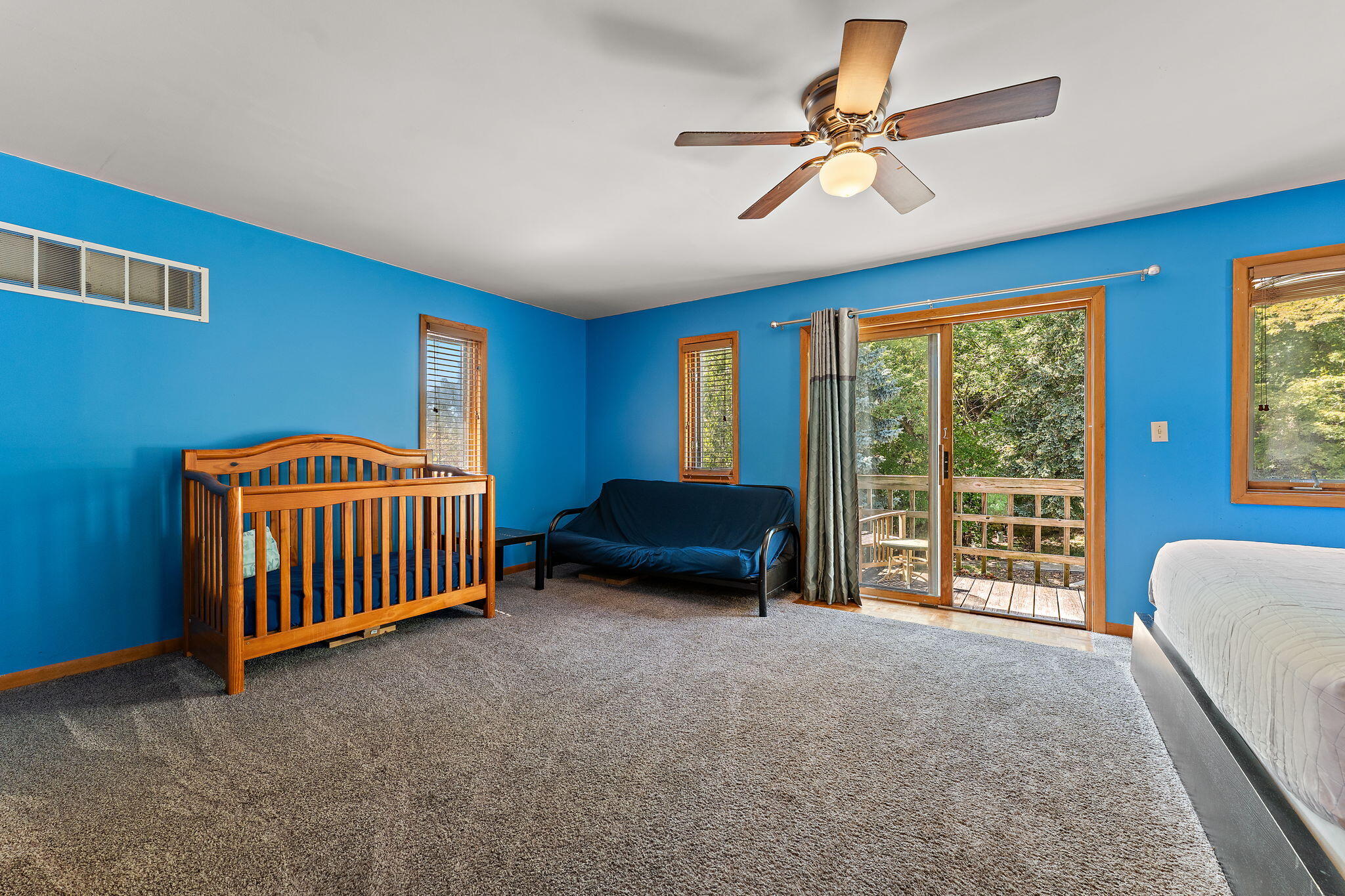 225 Warren Road Michigan City, IN 46360 - Photo 18 of 47 a living room with a balcony a bed and a chandelier