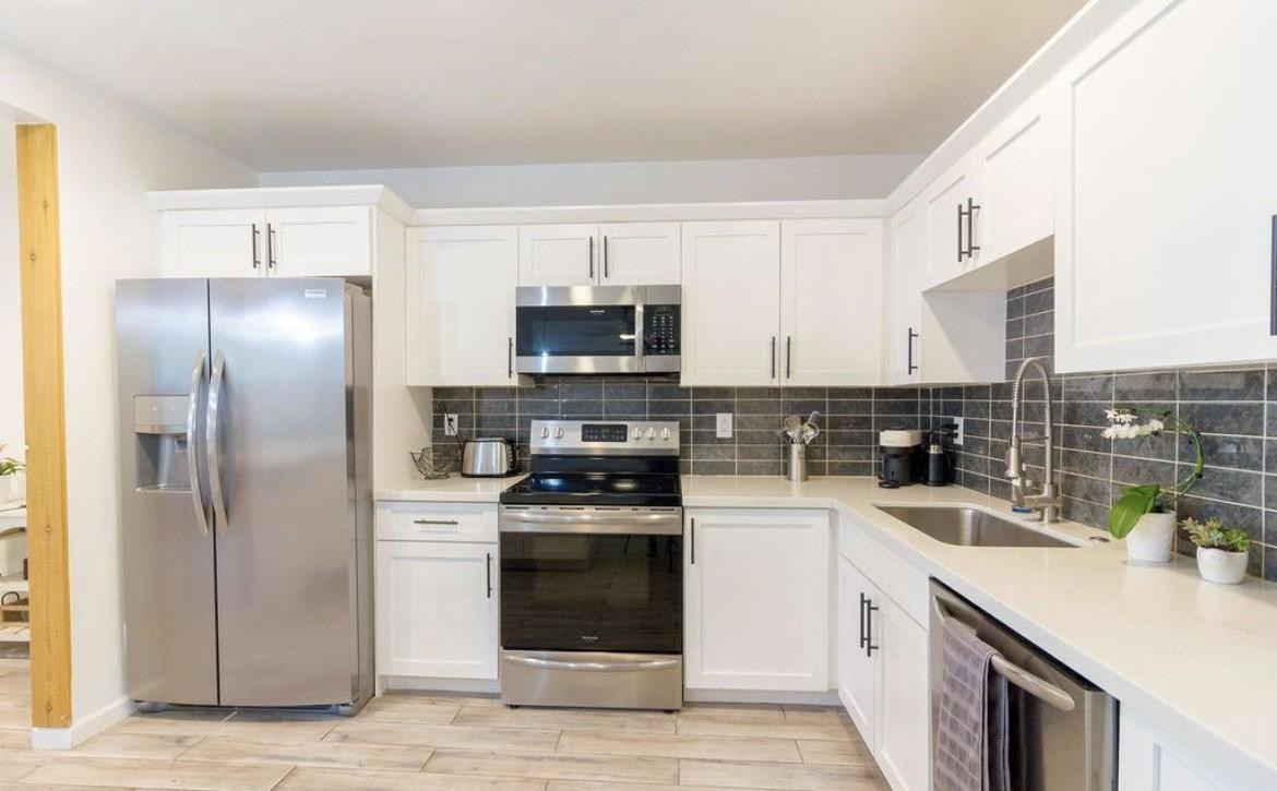 4214 North 20th Street Phoenix, AZ 85016 - Photo 37 of 40 a kitchen with a sink stainless steel appliances and cabinets