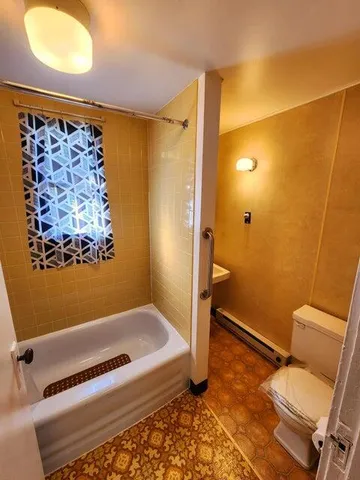 a bathroom with a bathtub and shower
