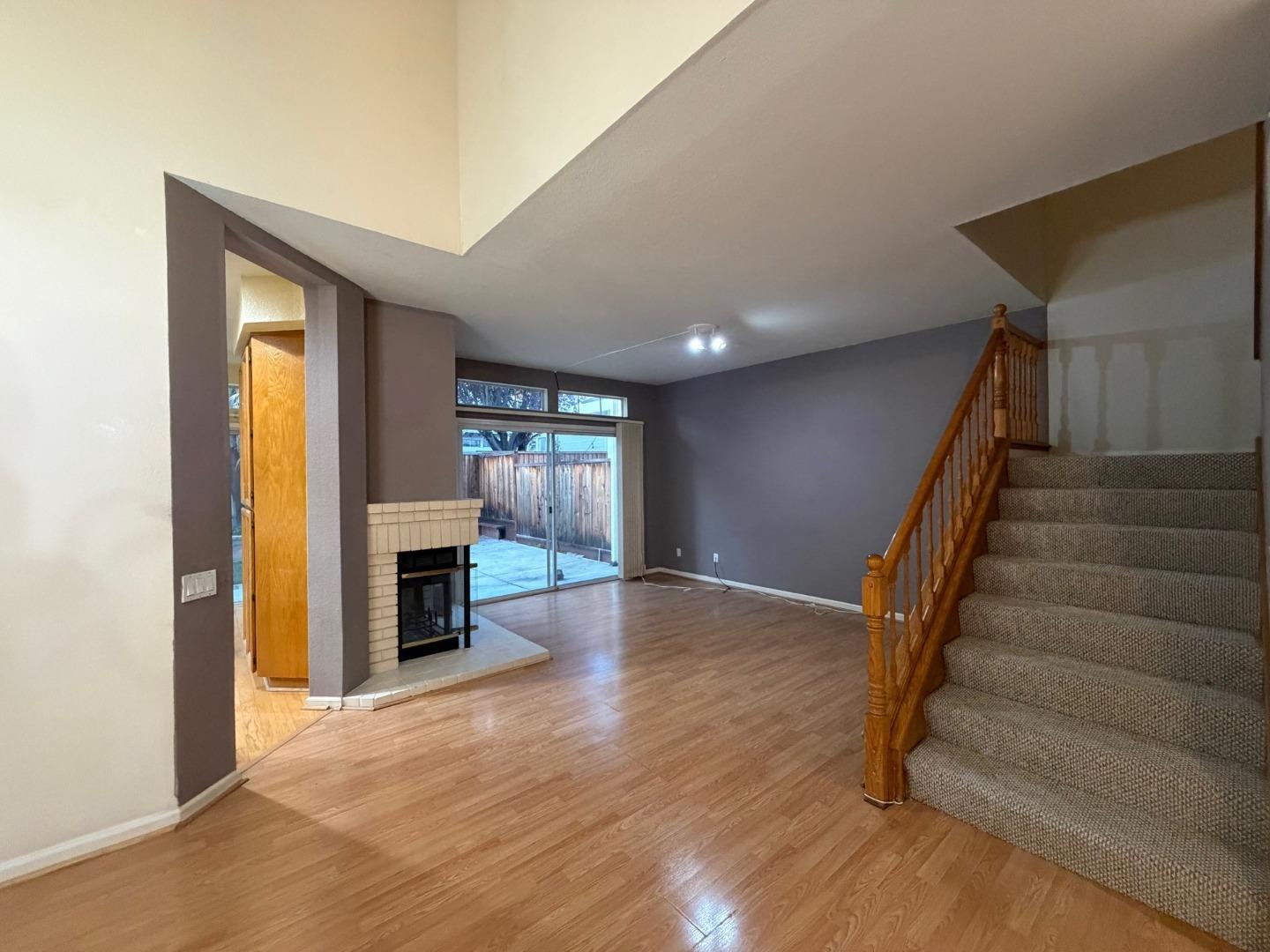 5417 Ridgewood Drive Fremont, CA 94555 - Photo 11 of 36 a view of an empty room with wooden floor fireplace and a window