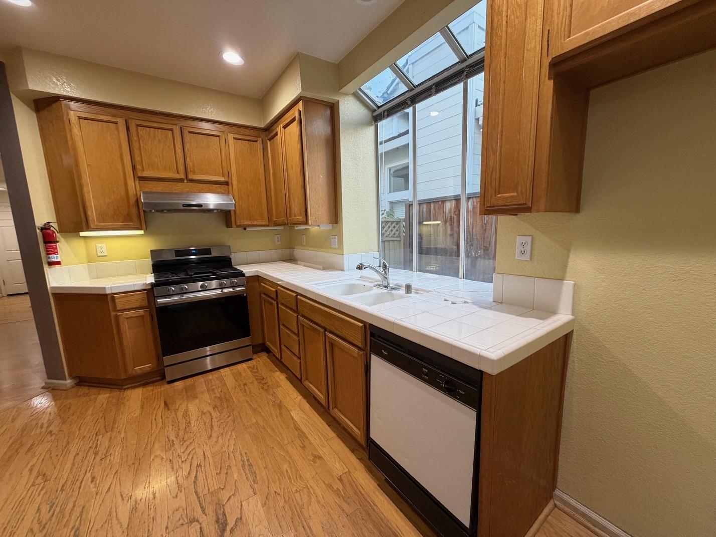 5417 Ridgewood Drive Fremont, CA 94555 - Photo 15 of 36 a kitchen with a sink stove and refrigerator