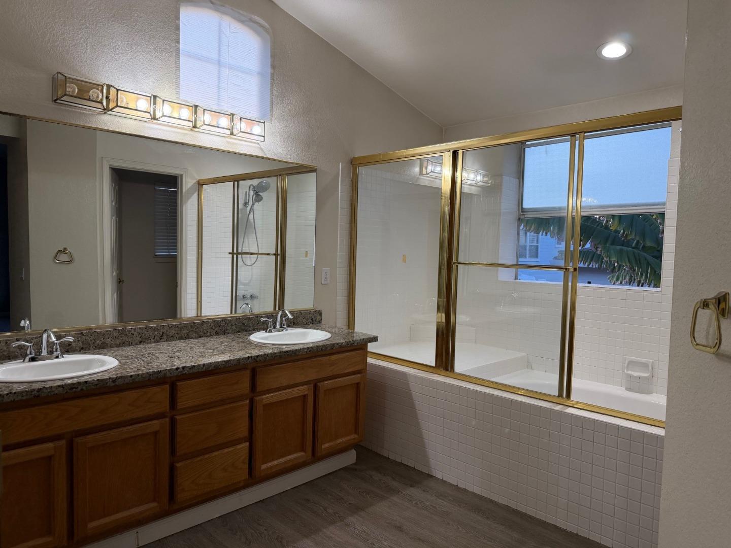 5417 Ridgewood Drive Fremont, CA 94555 - Photo 24 of 36 a bathroom with a granite countertop sink and a large mirror