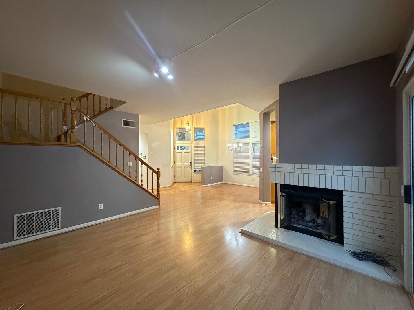 5417 Ridgewood Drive Fremont, CA 94555 - Photo 9 of 36 a view of an empty room with wooden floor fireplace and a window