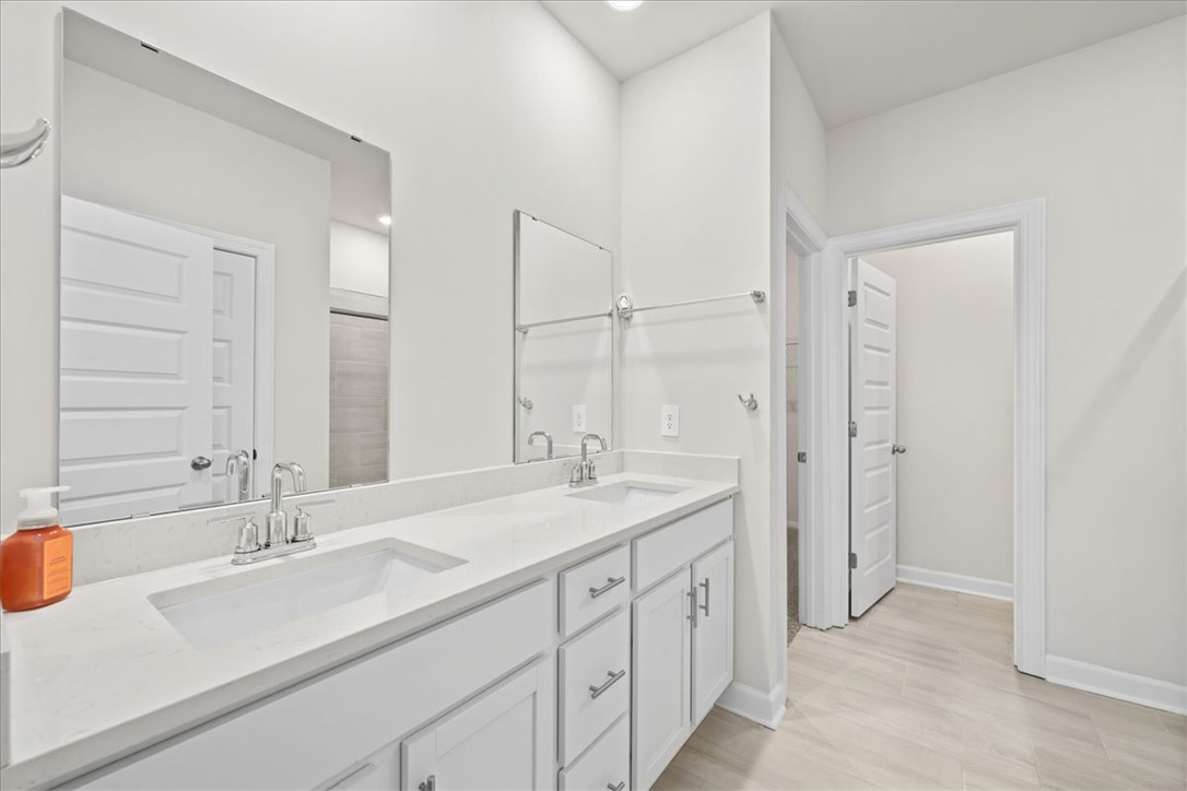 106 Purcell Way Easley, SC 29642 - Photo 21 of 39 This bright bathroom features a spacious double vanity with ample storage and modern finishes.