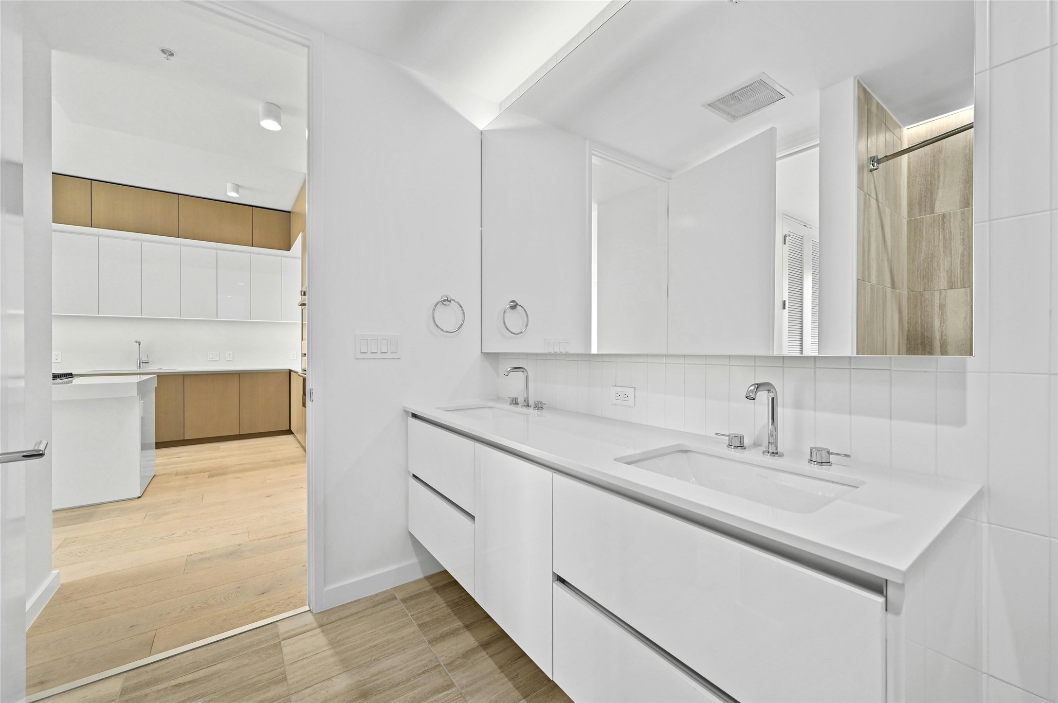 313 West 17th Street, Unit 2103 Austin, TX 78701 - Photo 14 of 39 The primary bathroom features a luxurious dual vanity with a large mirror, providing ample space for daily routines and adding a touch of elegance.