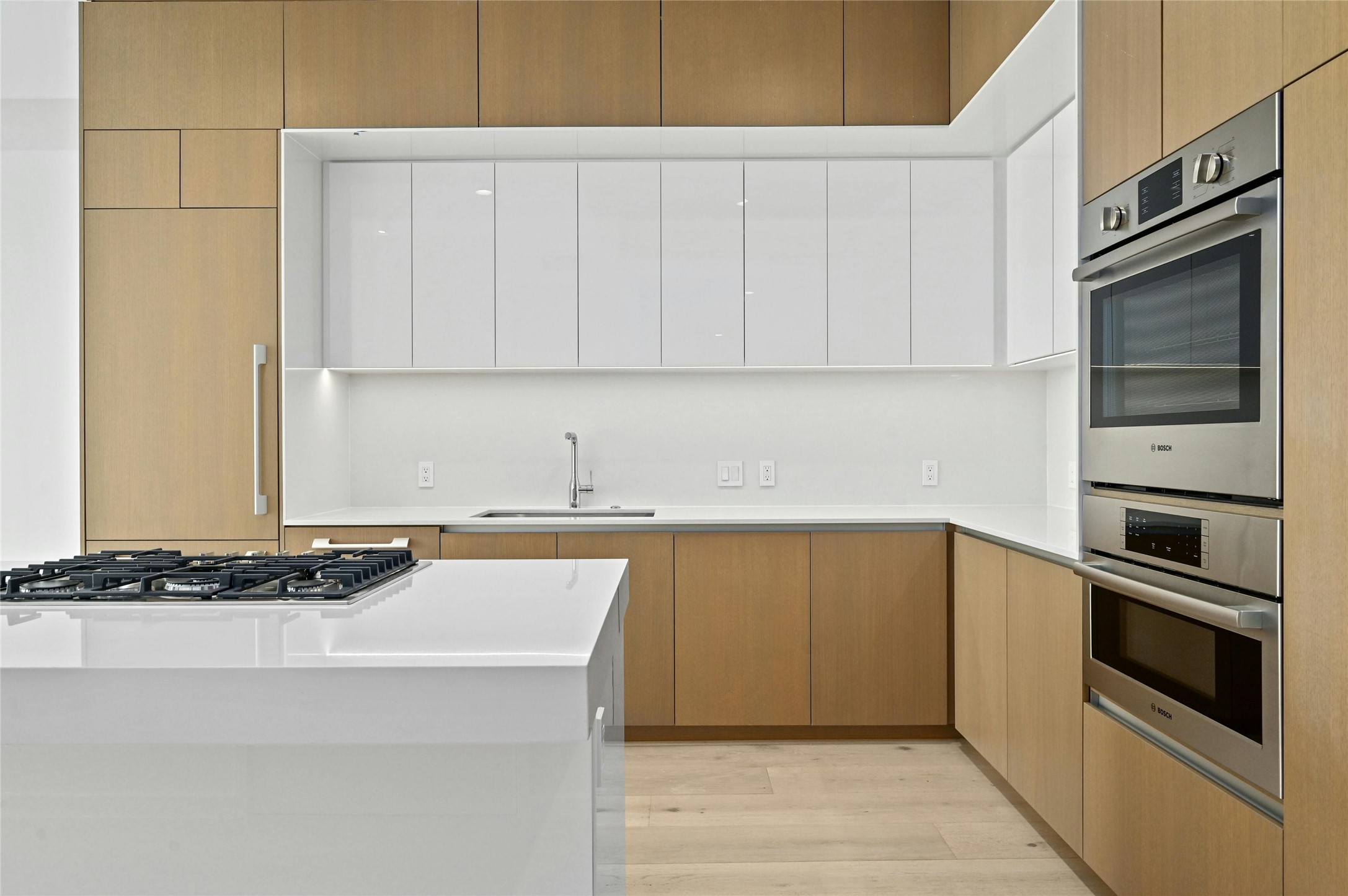 313 West 17th Street, Unit 2103 Austin, TX 78701 - Photo 2 of 39 A culinary masterpiece, designed for both functionality and style. The Silestone® island, a centerpiece designed by award-winning firm Rhode Partners, offers ample space for meal prep & casual dining. A gas cooktop & suite of integrated Bosch® appliances maintain a streamlined look & feel and cater to culinary enthusiasts. Abundant natural light floods the space, highlighting the clean lines & premium materials, creating a kitchen that is both inviting & sophisticated.