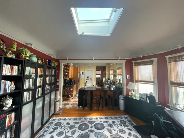 a living room with furniture a rug and a window