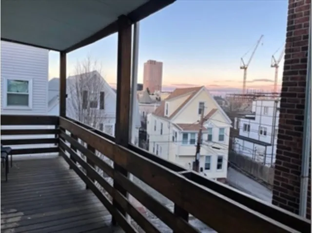 a view of a balcony with furniture