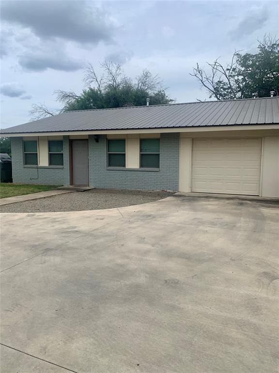 2302 Mesquite Lane, Unit A Georgetown, TX 78628 - Photo 1 of 11 a front view of a house with a yard