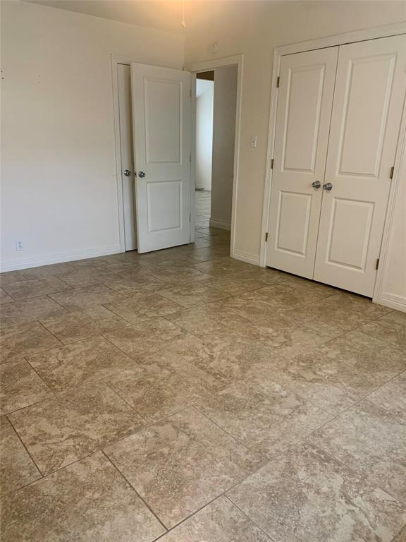 2302 Mesquite Lane, Unit A Georgetown, TX 78628 - Photo 6 of 11 Unfurnished bedroom with a closet and baseboards